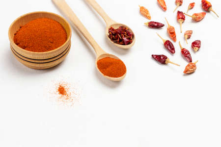 Dry paprika petals in bowl, dry pepper pods and ground paprika in bowl. Flat lay. White background. Copy space.の写真素材