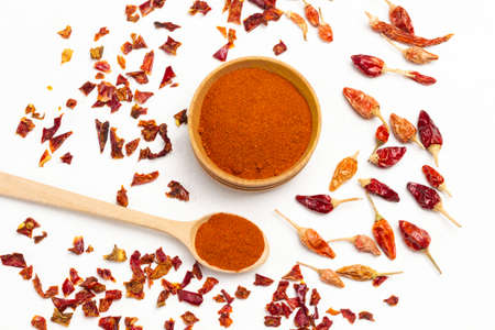 Dry spices on white. Dry paprika petals, dry paprika petals and ground paprika in bowl. Flat layの写真素材