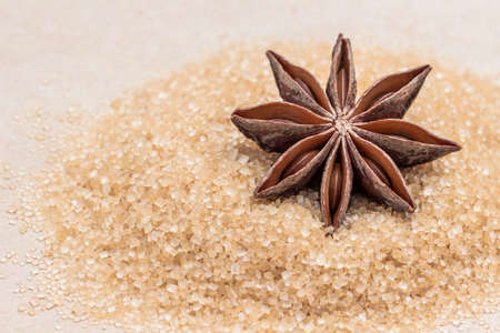 Dry star anise with brown sugar. Beige background. Close upの写真素材