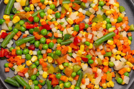 Vegetable mix of carrots, corn, asparagus on black plate. flat layの写真素材
