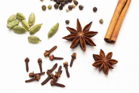 Dry spices: cardamom, star anise, cinnamon sticks and allspice. top view. white backgroundの写真素材