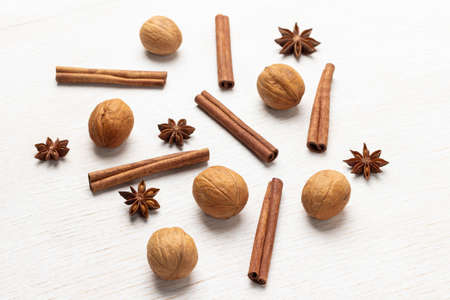 Walnut, cinnamon sticks and star anise. top view. white backgroundの写真素材
