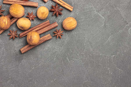 Walnut, star anise and cinnamon sticks on black. copyspace. flat lay. black backgroundの写真素材