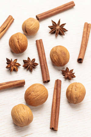 Walnuts, star anise and cinnamon sticks on the table. flat lay. white backgroundの写真素材
