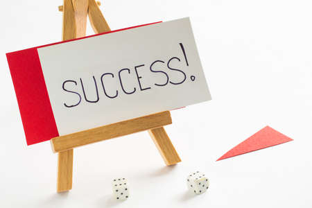 SUCCESS word on the card. Card on a wooden rack. white backgroundの写真素材