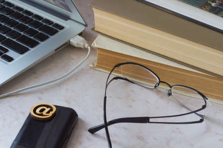 Business - still life. Laptop, old books, the phone on the desktopの写真素材