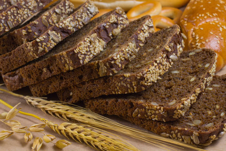 Dark and white bread, sticks of barley - on the tableの写真素材