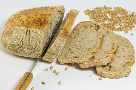 White bread, knife, slices of bread and wheat