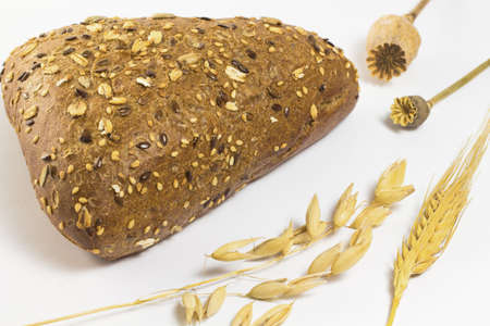 Black bread with sesame seeds and sunflower seeds. Twig barley and oats. two poppiesの写真素材