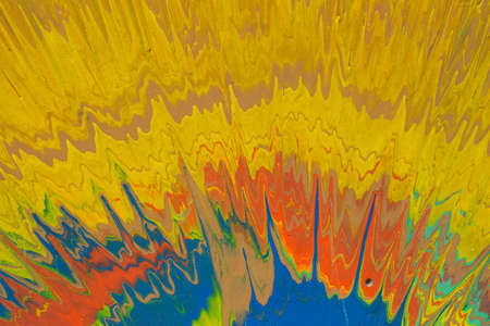 Mustard, blue and red paint splashes on the cardboardの写真素材