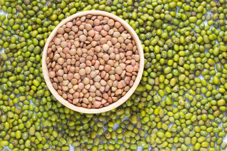 Green lentils. Brown lentils in a wooden bowlの写真素材