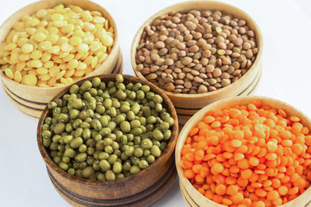 Four varieties of lentils in wooden bowls