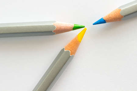 Three pencils: blue, yellow and green. white backgroundの写真素材