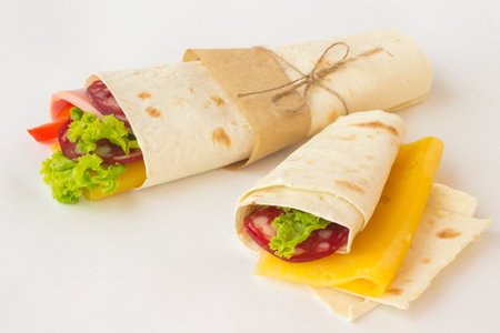 Tortilla rolls with smoked meat and vegetables on a white background. Outdoor Food Conceptの写真素材