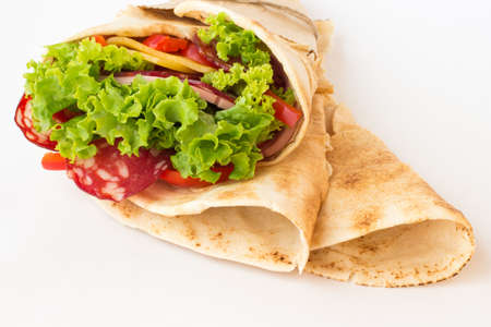 Roll tortilla with herbs, cheese and meat on a white backgroundの写真素材