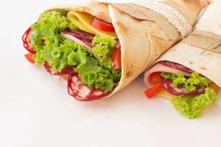 Tortilla rolls with smoked meat and vegetables on a white background. Outdoor Food Concept. close upの写真素材