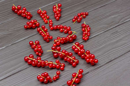 Berries of ripe red currant on dark wooden background. copyspace. flat layの写真素材