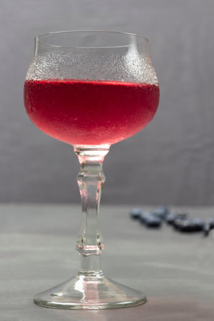 Wine glass with cooling drink. Drops of water on misted glass of wine glass. gray backgroundの写真素材