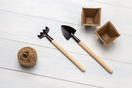 Peat pots and garden tools on a white background. flat layの写真素材