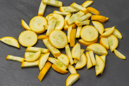 Sliced yellow zucchini on the table. flat lay. gray background.の写真素材