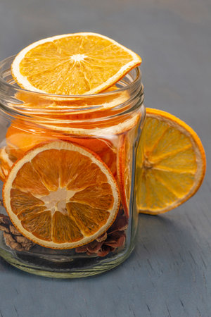 Orange slices in a glass jar. close up. gray background.の写真素材