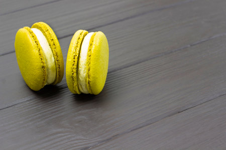 Two macaroni cakes. copyspace. Dark wooden background.の写真素材
