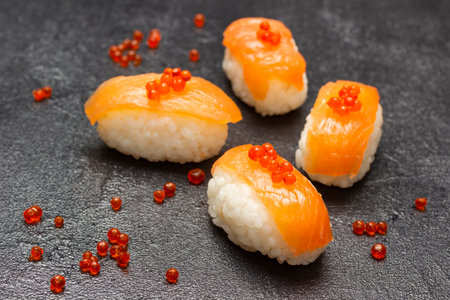 Salmon nigiri with caviar. top view. black backgroundの写真素材