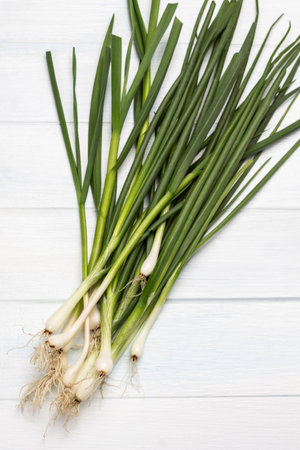 Fresh Green onions with roots. flat lay. white background.の写真素材