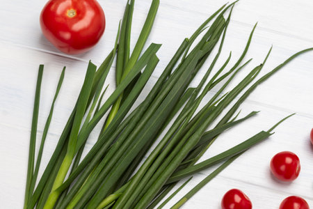 Tomatoes and green onions on a white background. top viewの写真素材
