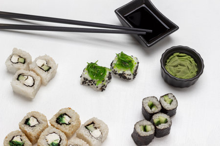 Sushi set, wasabi, soy sauce and black chopsticks. flat lay. white backgroundの写真素材