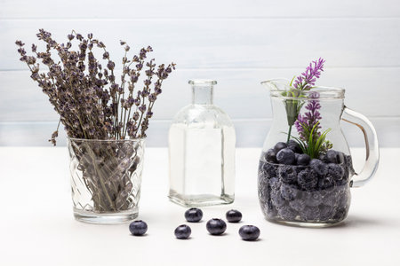 Sparkling blueberry water in glass jar. Lavender in glass. Water bottle. white background.の写真素材