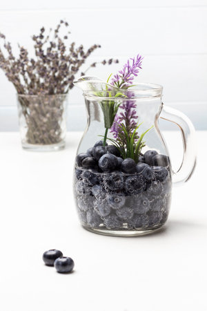 Sparkling water with blueberry in glass jar. Lavender in glass. top view. white background.の写真素材