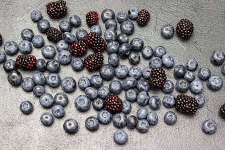 Ripe berries of blackberries and blueberries. flat lay. Black background.の写真素材
