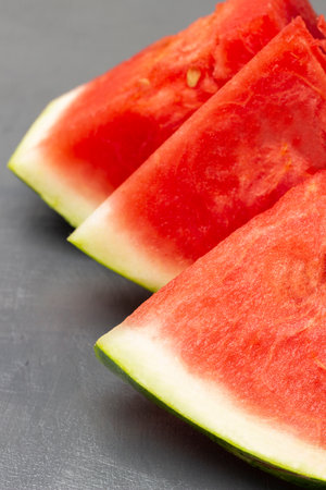 Three pieces of watermelon, part of the frame. close up. gray background.の写真素材