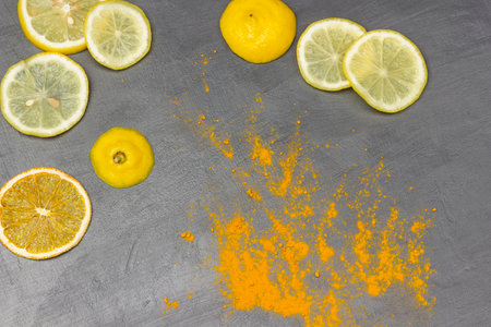 Dry turmeric and lemon slices on a gray background. flat lay.の写真素材