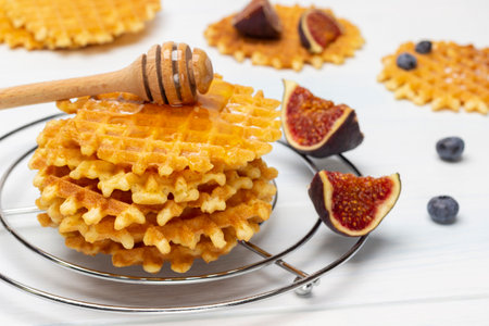 Wafers with honey, honey stick and figs. close up. white background.の写真素材