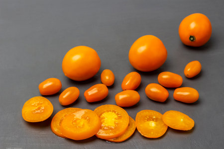 Fresh orange tomatoes, sliced tomato. copyspace. top view. gray background.の写真素材