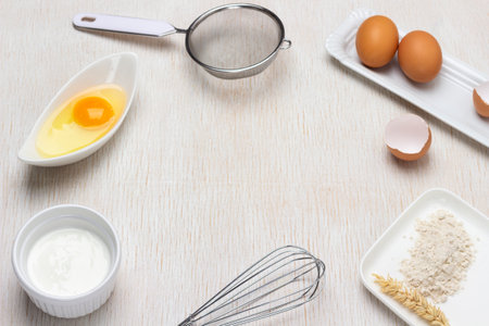 Ingredients for making dough. Flour, eggs and cream. Sieve and whisk. copyspace. top view. white backgroundの写真素材