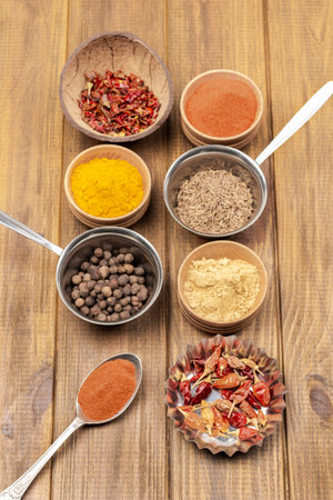 Set of dry spices in bowls. flat lay. wooden backgroundの写真素材