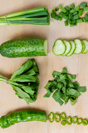 Sliced green vegetables on a cutting board. top viewの写真素材