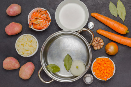 Seafood and vegetables ingredients for cooking clam chowder soup. Natural source of omega-3. Black background. Flat layの写真素材