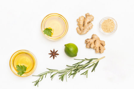 Ginger, rosemary sprig, tea and lime. Treatment of colds and flu. White background. Flat layの写真素材