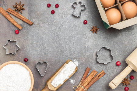Ingredients for cooking Christmas baking on dark rustic baking tray. Christmas Baking background. Flat layの写真素材