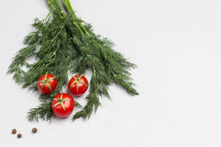 Dill sprigs and tomatoes. Gray background. Plant wallpaper Flat lay. Copy spaceの写真素材