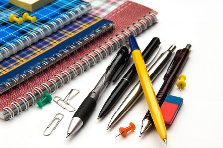 stationery pen notebook pencil on a table