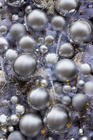 Background of New Year decorations: silver balls and silver fir branches. Close-up.の写真素材