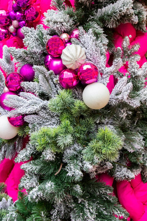 Christmas garland made of frosted fir branches and multi-colored balls.の写真素材