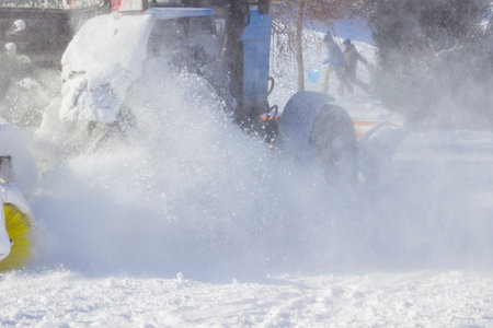 Snow removal machine cleaning road from snow during blizzard in winter. Part of the frameの写真素材
