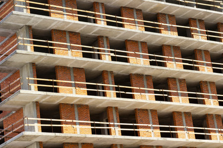 Beginning of construction: reinforced concrete floors and brick walls of the house. Close up.