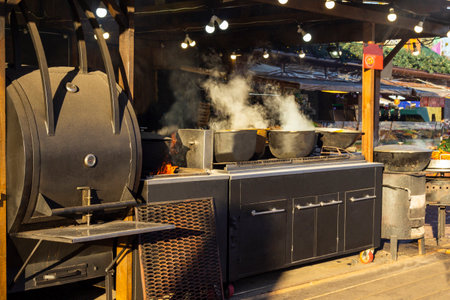 Two large pots on the stove in an outdoor kitchen. Steam comes out of the pots.の写真素材